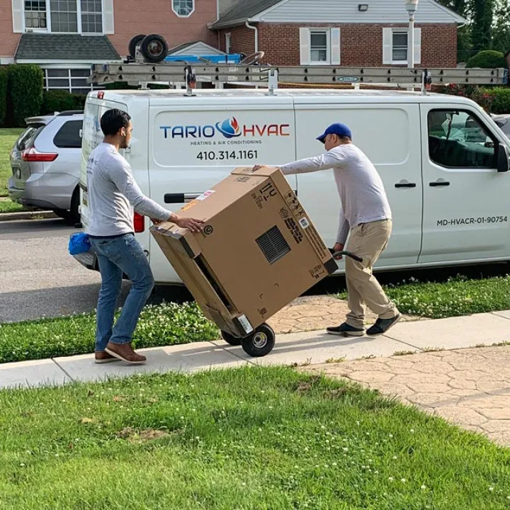 Tario HVAC crew installing a ductless mini-split outdoor unit on a brick home