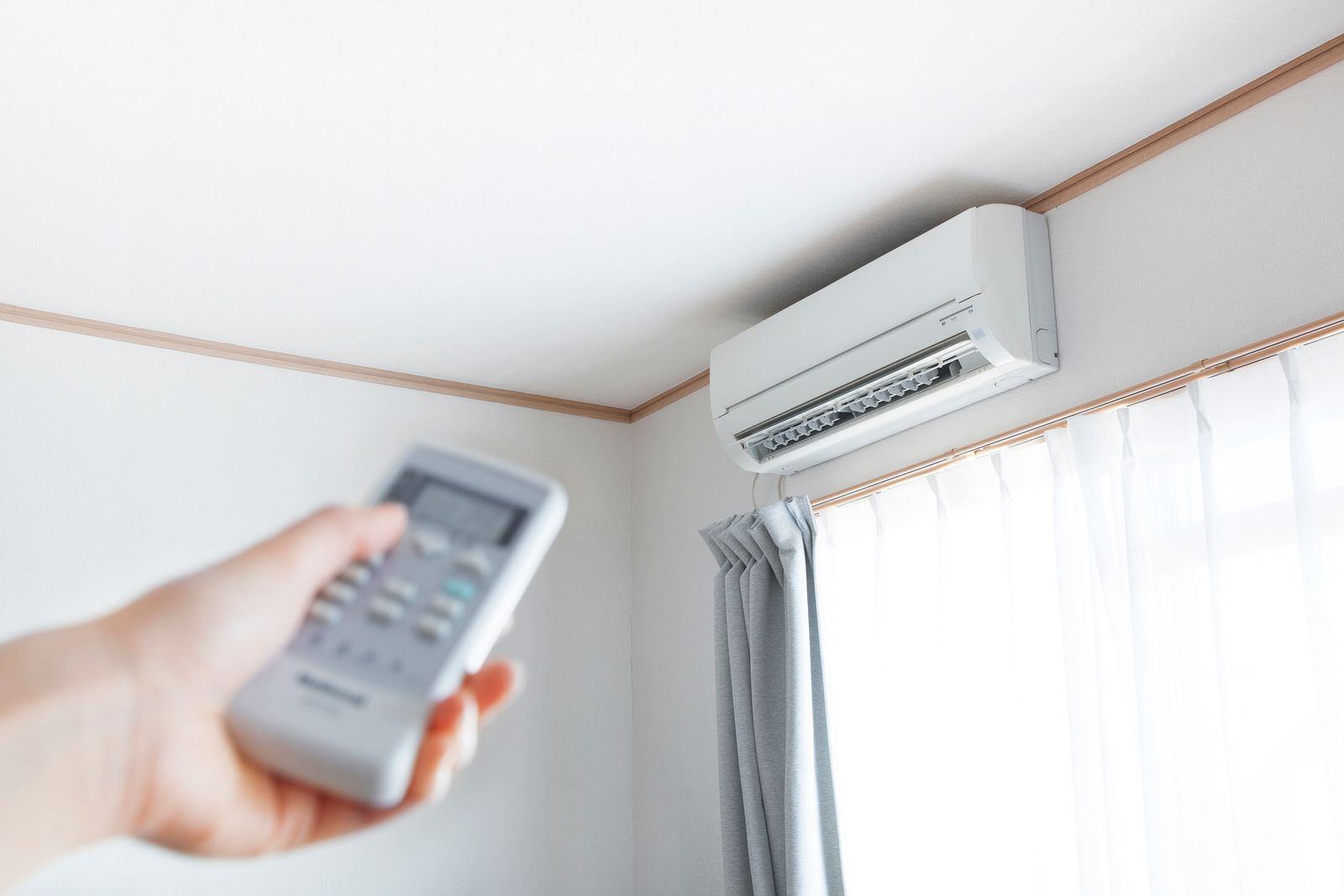 Tario HVAC technician performing a maintenance tune-up on an outdoor AC unit